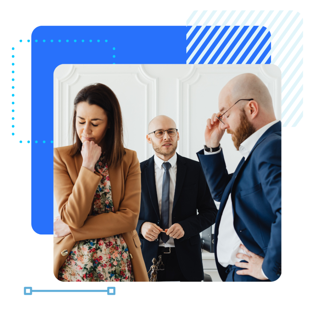 Three insurance workers stand in discussion, looking upset and serious.